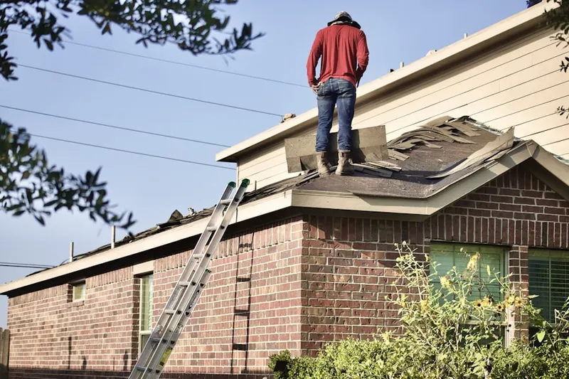 Professional roofer working on a residential roof in Mooresville